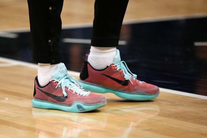 View of red and teal Nike Kobe shoes.
